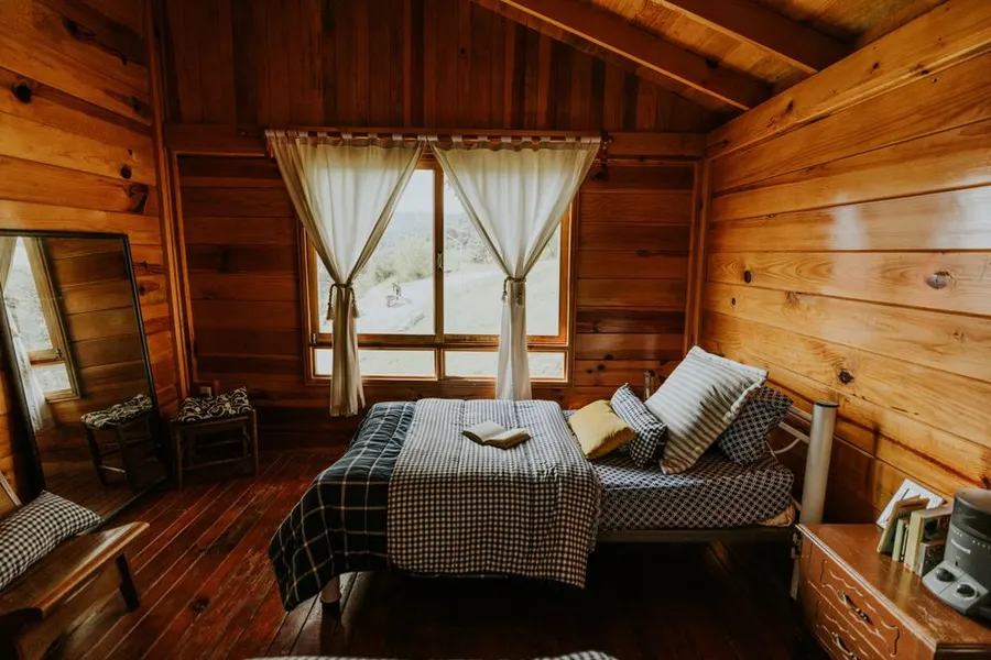 A tidy wooden cabin bedroom